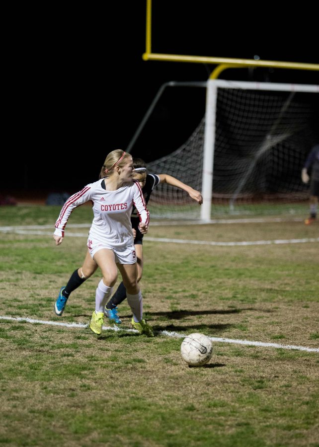 Forward Junior Macey Williamson (3) dribbles the ball away from a Washington defender during Tuesdays night 3-0 win. 