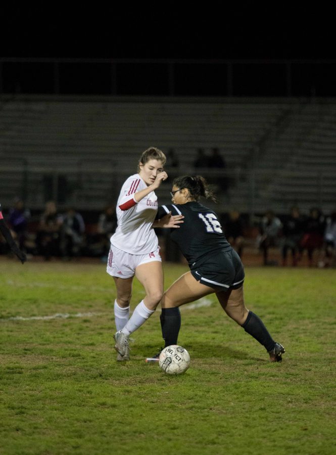 Middle forward Kayla Horton (14) dribbles the ball away from a Washington defender during Tuesdays night 3-0 win. 
