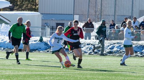Midfielder Makenzie Cloud (#15) attempts to take possession of the ball from Liz McDonough (#2).