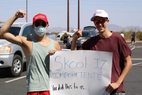 Seniors Chad Moyes and Cameron Ricks march down Germann Road holding a sign that implies they have forgotten how to spell because of virtual learning. Community members marched from Combs High School to the J. O. Combs Unified School District Office in protest of the decision to cancel school due to more than 100 staff calling in sick over safety concerns related to COVID-19.