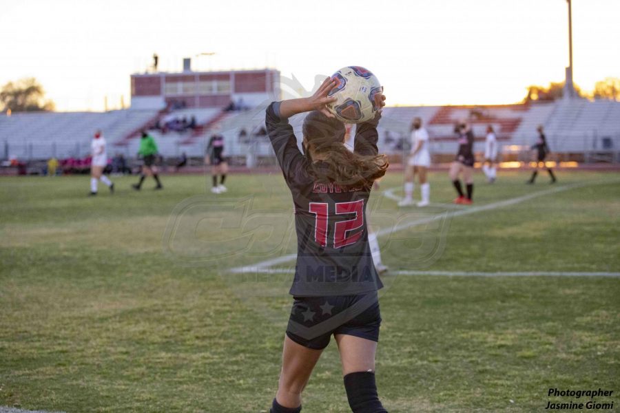 Senior defender Alexia Quinonez (12) throws the ball in during the first half of the game against the Sention Catholic Sentials on Tuesday night February 23.