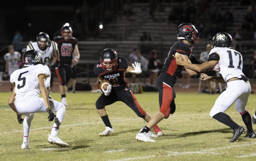 After a completed pass junior runningback Tanner Nino (2) tries to juke out AJ defensive back Ben Valenzuela (5).