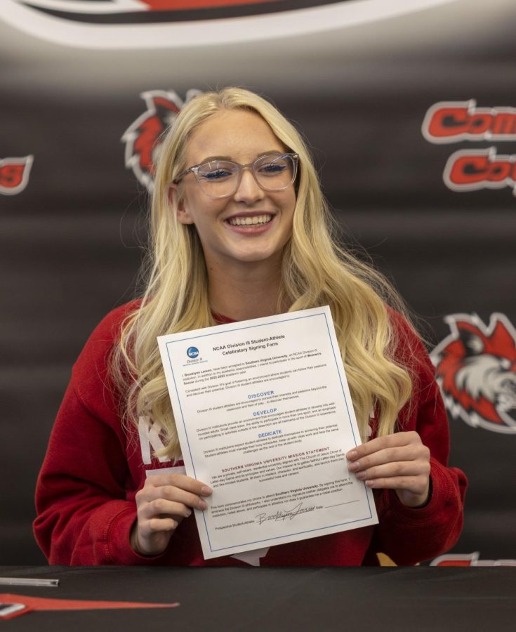 Senior Brook Larson holds up her signed letter of intent to attend Southern Virginia University.