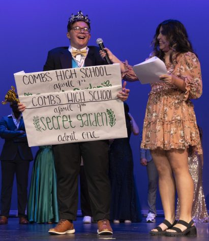 Mr.CHS winner Mack Olsen wears a huge smile on his face as he holds his two tickets for the Secret Garden prom.