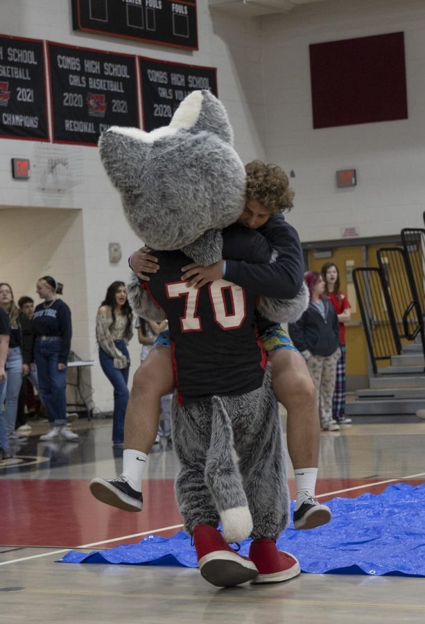 Senior Brodee Tucker jumps into the arms of Cody the Coyote.