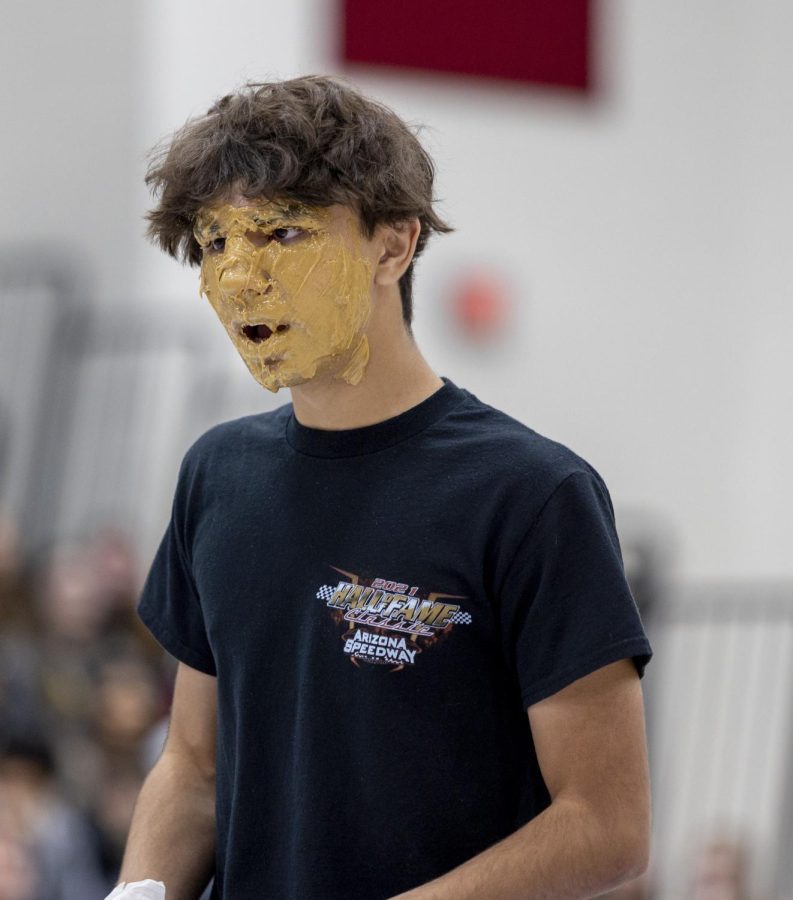 Senior Jason Khan chooses to clean his face with peanut butter over washing his hands with syrup with a twist. Instead of a spoonfull of peanut butter he stuck his hand into the jar.