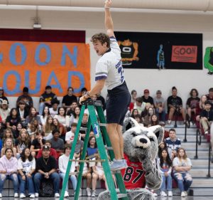 At the top of the ladder, senior Cooper Schnepf screams in celebration as the winner of the scavenger hunt musical chair game.