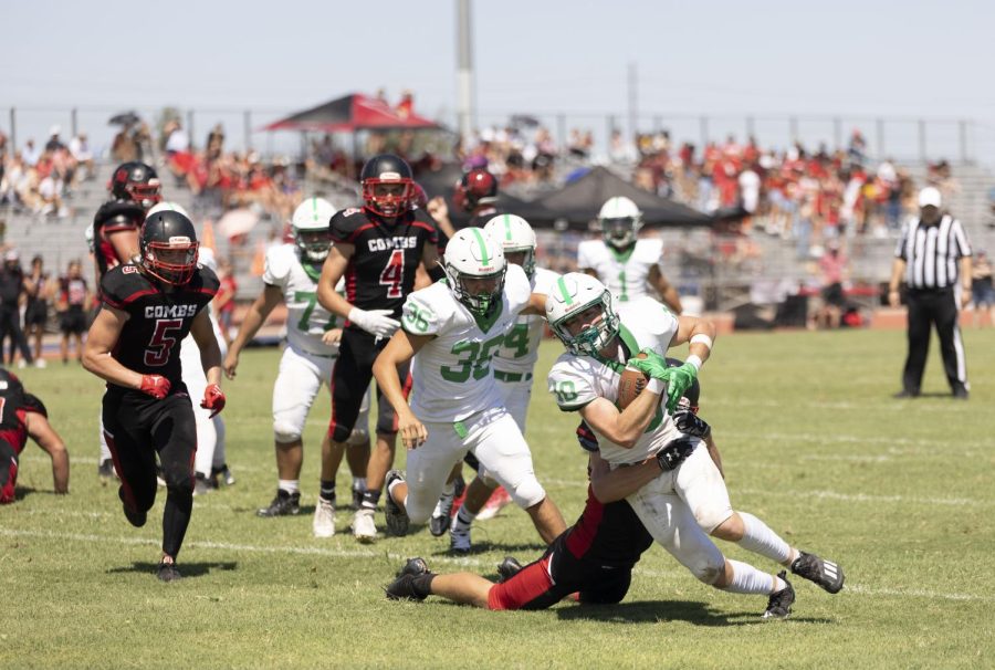 Defensive lineman Gage Theabold tackles St. Mary’s wide receiver PJ Lewis. The Coyotes lost to the Knights 21-15 on a rare Saturday morning game.