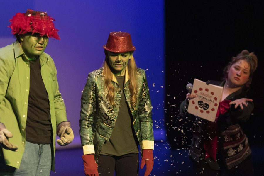 The Grinches (played by Aidyn Wahl and Mya Palmer) look off in shame as host Alina Gerasimova showers them in snow.