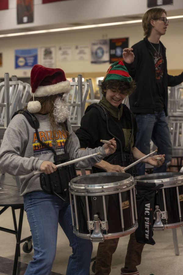 As the marching band plays No Doubts Hey Baby, drummers Rachel Lyon and River Holt synchronize their drumming.